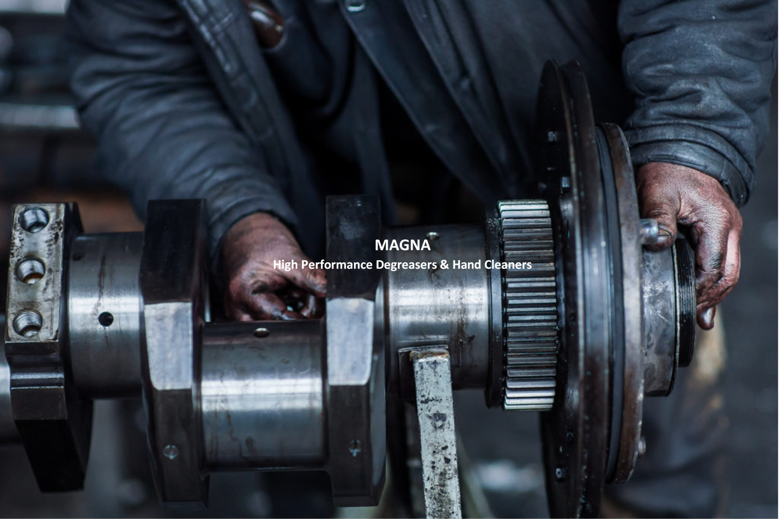 Man working on large metal engine part covered with grease and oil