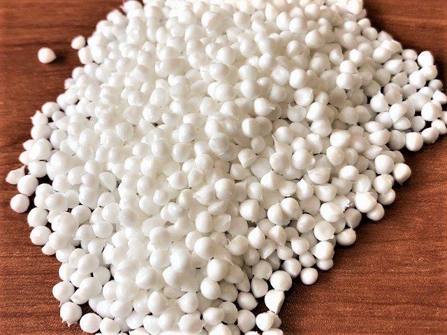 Small pile of white Masterbatch plastic resins lying on a desk