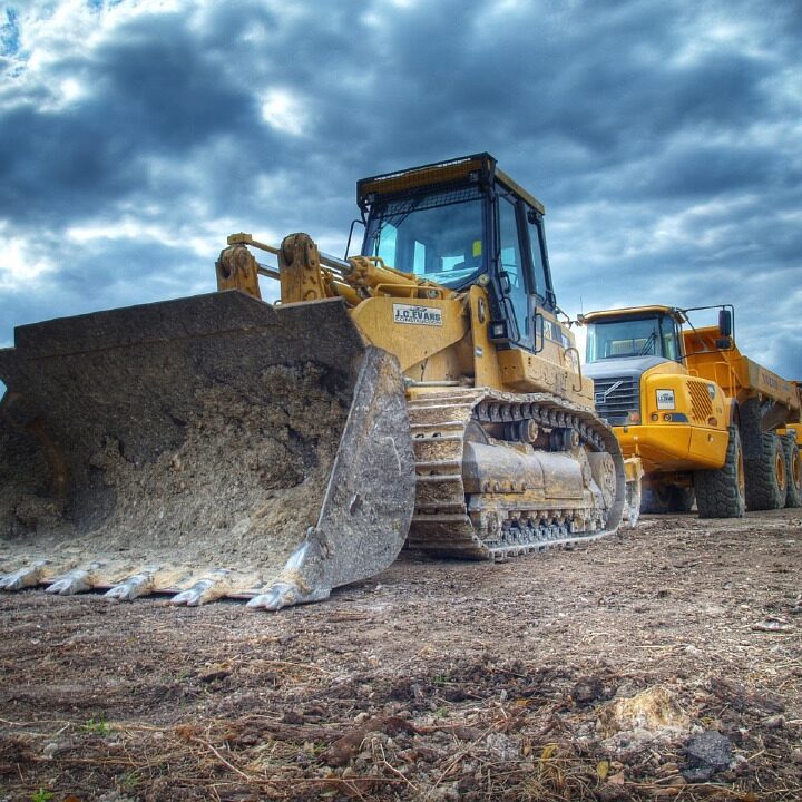 Bulldozer and large trucks parked in surface mining operation with VCI corrosion prevention